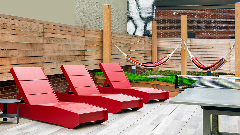 Second Floor Courtyard with Red Lounging Sun Chairs, Hammocks and Ping Pong Table