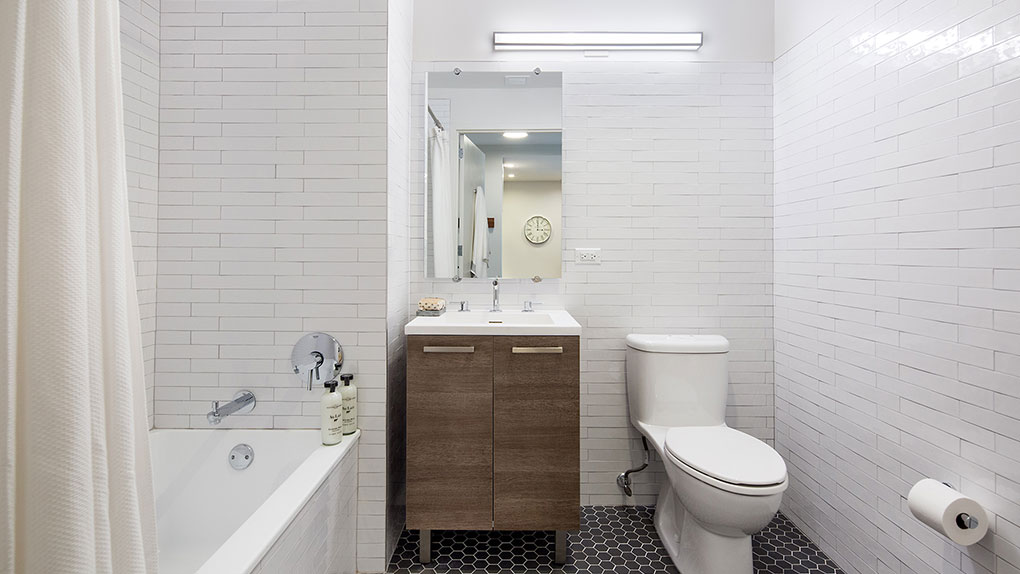 Modern Bathroom with White Tile From Floor to Ceiling and Single Vanity